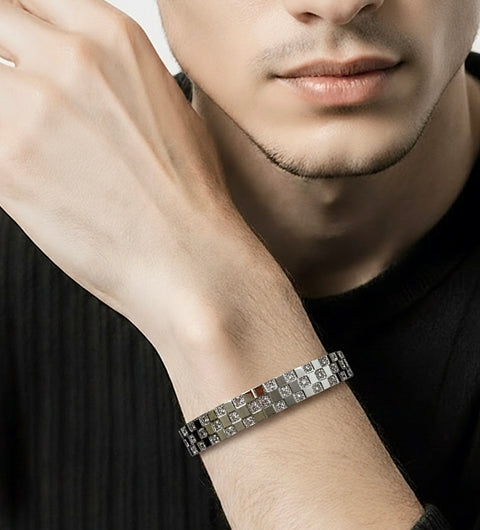 Close-up of a person wearing a B.Tiff BG104W trellis silver bracelet on a plain background