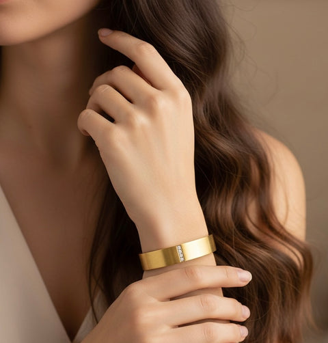 B.Tiff BG223G 18k Gold plated bangle with 4 stones paved in central column on a person's wrist with a neutral