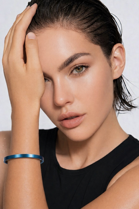 Woman wearing B.Tiff BG300BL blue bangle bracelet on her wrist against a white background