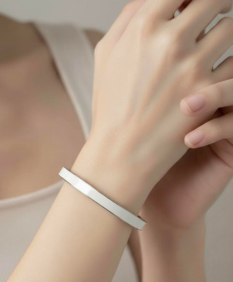 B.Tiff BG301WW white enamel Silver bracelet on a wrist with a neutral background