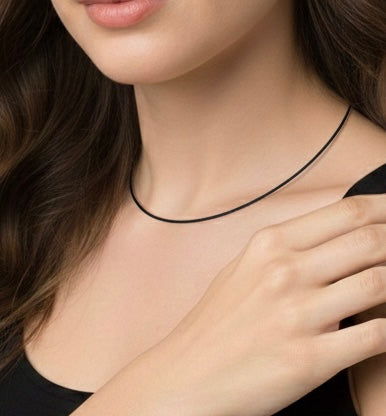 Close-up of a person wearing a B.Tiff C015B anodized titanium plated black cable wire necklace