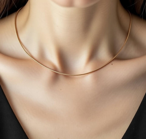 B.Tiff C015RG rose gold cable wire necklace on a person's neck with a blurred background