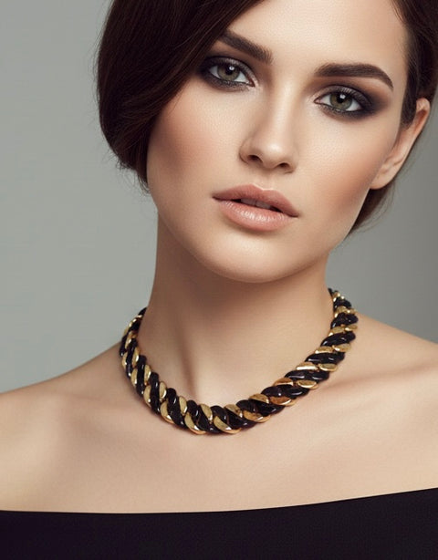 Woman wearing a B.Tiff C160BG 16mm 2 tone gold and black Cuban link chain necklace against a gray background