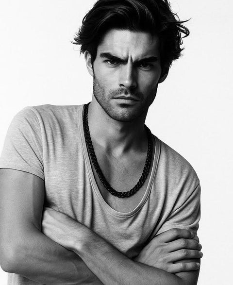 Black and white portrait of a man with arms crossed wearing B.Tiff C160B 16mm black Cuban link chain necklace