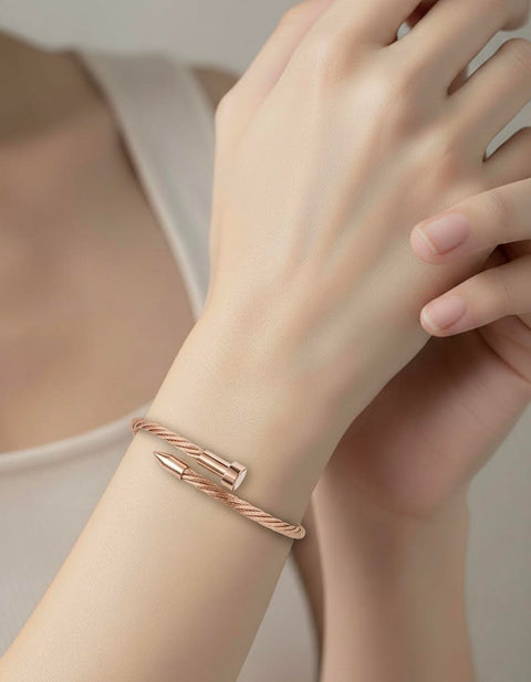 B.Tiff BF004RG Rose gold cable bracelet on a wrist with a blurred background