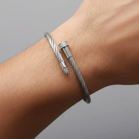 B.Tiff BG005W Silver adjustable bracelet paved with diamond alternative gemstones in an industrial nail design on a wrist against a gray background