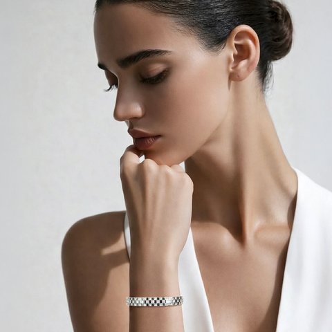 Woman wearing a B.Tiff BG104W Trellis silver bracelet on a plain background