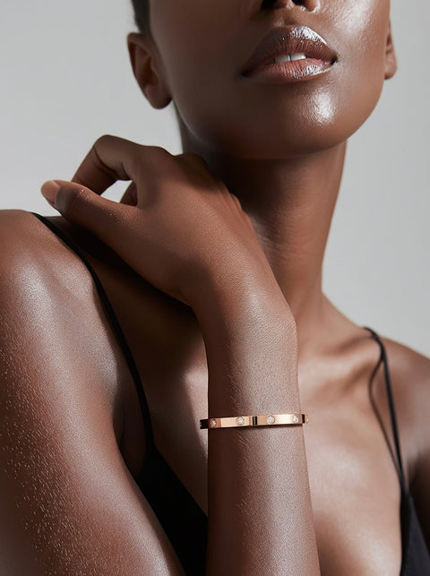 Close-up of a woman's arm wearing a B.Tiff BG308RG 8 stone high polish rose gold bracelet against a neutral background