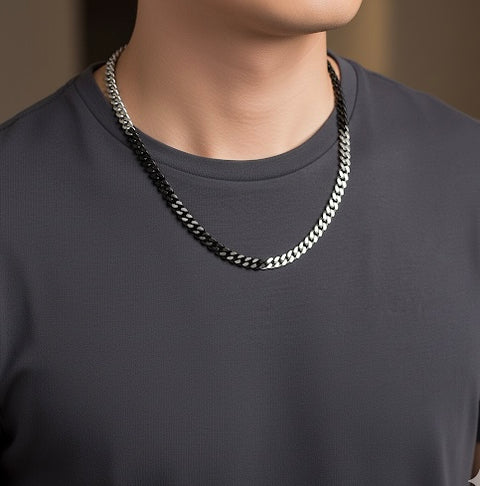 Person wearing a B.Tiff C138BW 8mm 2 tone black and silver Cuban link chain necklace on a plain background