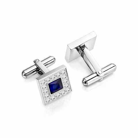 Silver cufflinks with a blue gemstone and clear stones on a white background