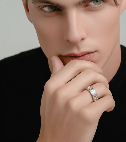Close-up of a man wearing a B.Tiff RG104W Trellis pave diamond ring with against a neutral background